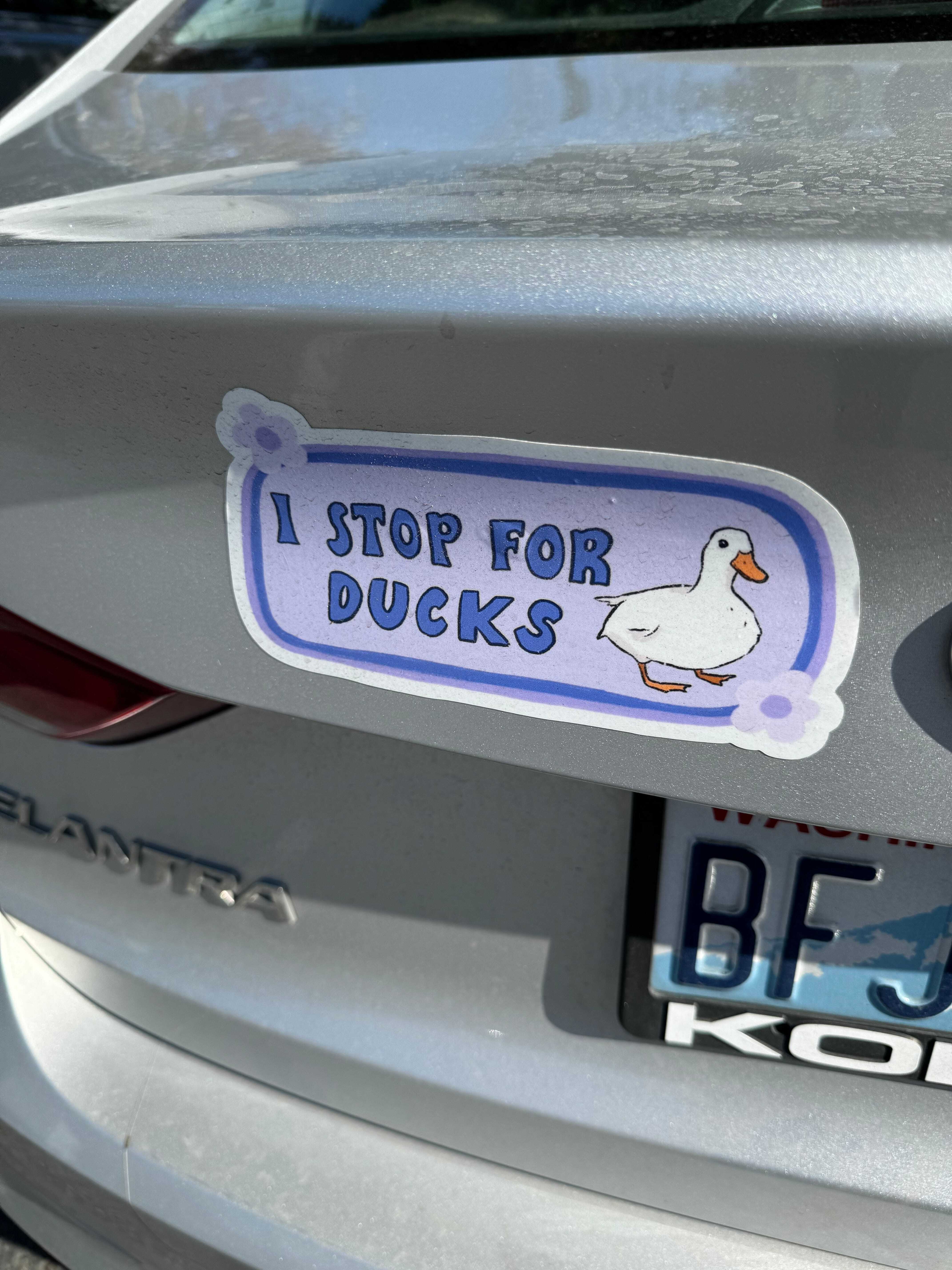 A bumper sticker reading “I stop for ducks” with a drawing of a duck.